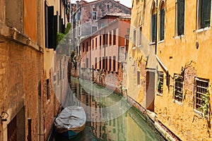 VENICE, ITALY Ã¢â¬â MAY 23, 2017: Traditional narrow canal street with gondolas and old houses in Venice, Italy.